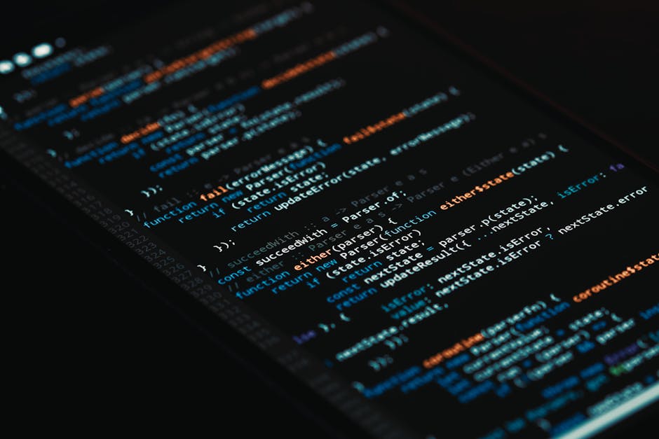 Laptop displaying programming code and a learning interface